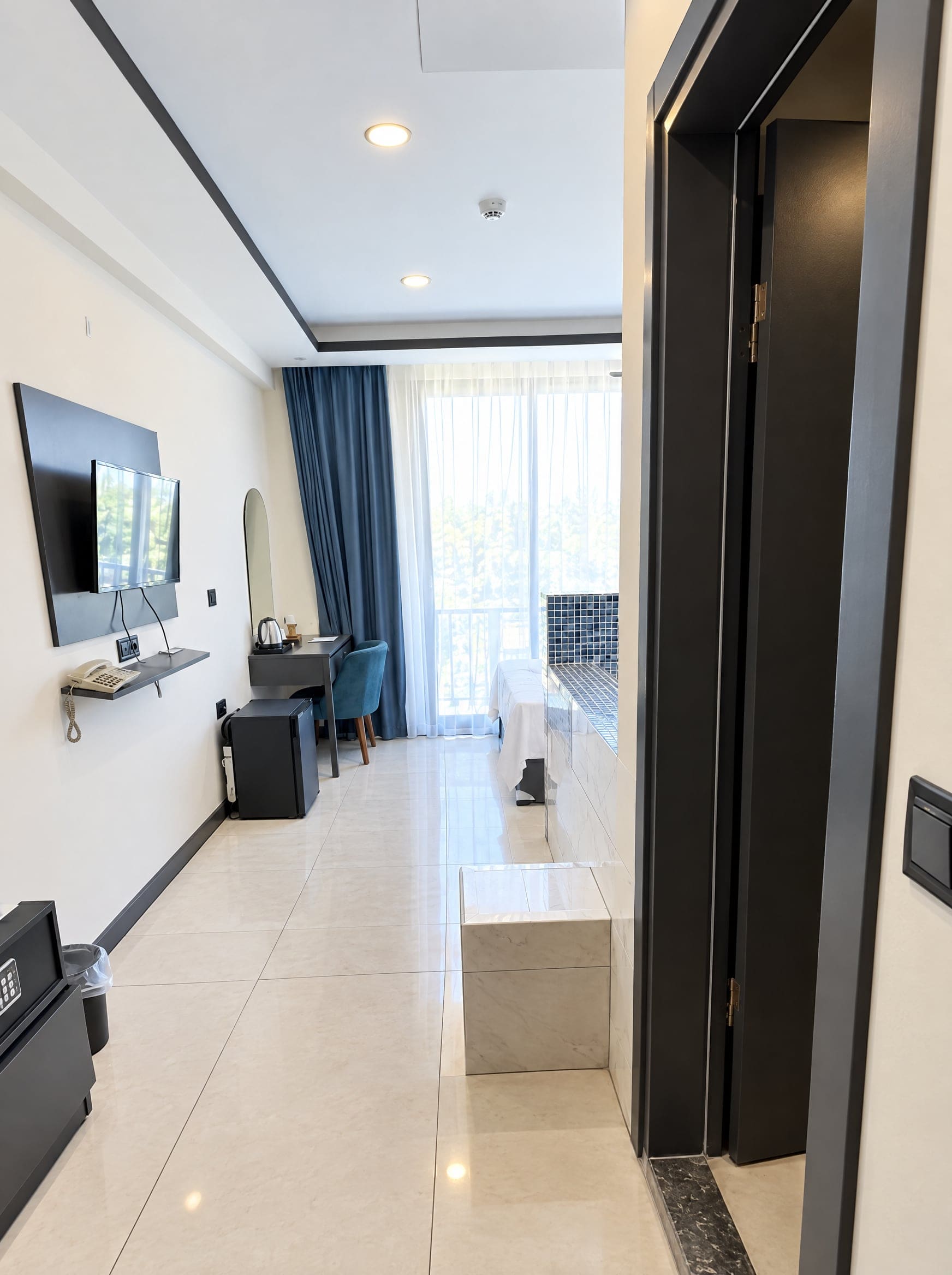 Suite Room: TV, desk and the room leading to the balcony
